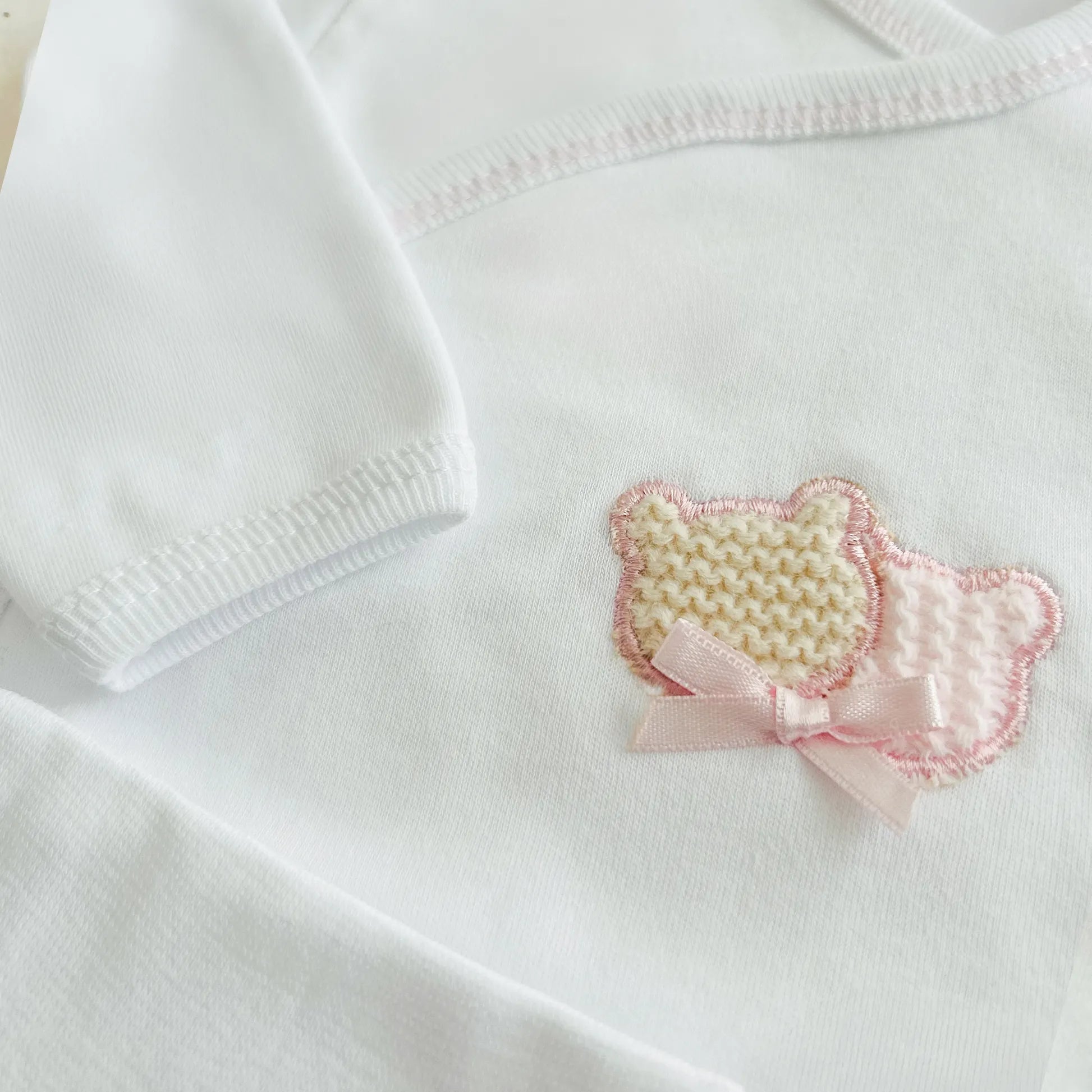 Pormenor de body de trespasse com collant cardado com motivo ursinhos tricot e lacinho rosa
