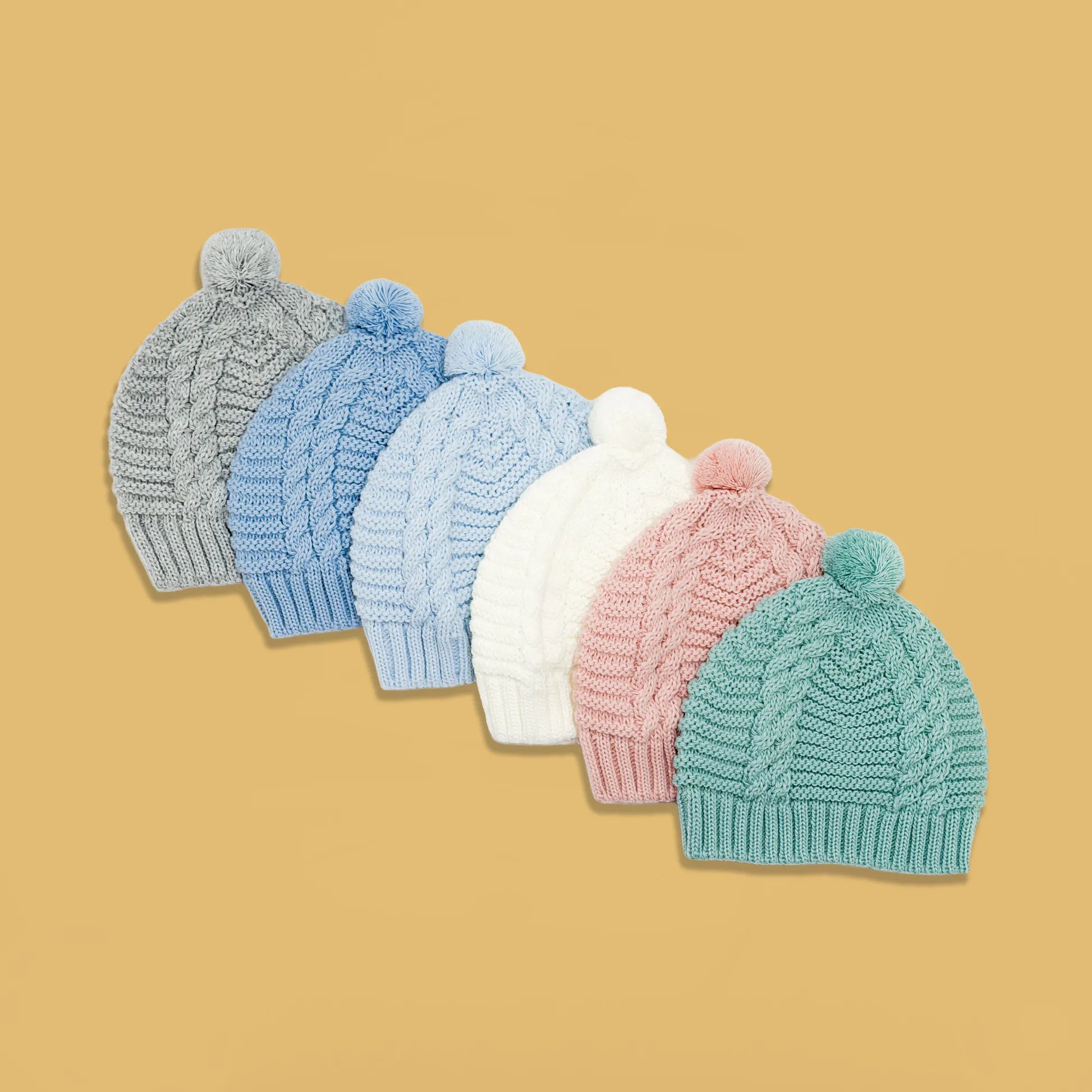 Gorros de malha tricotada com pompom nas cores cinza, cobalto, azul, pérola, rosa e verde