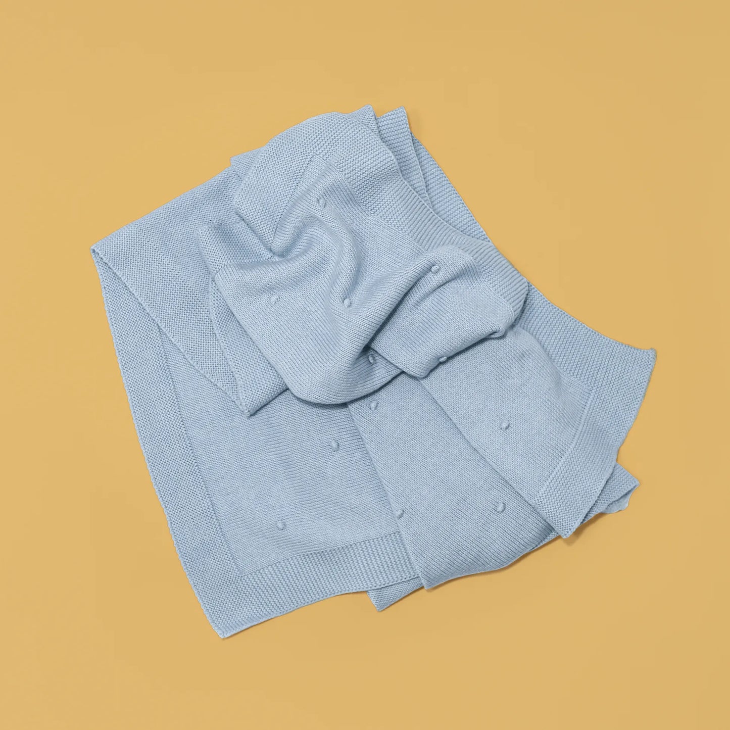 Manta em tricot com relevo de pompons azul