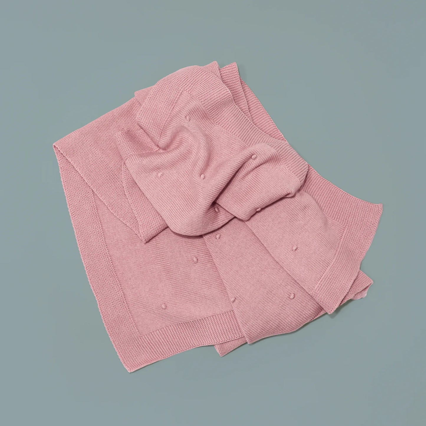 Manta em tricot com relevo de pompons rosa