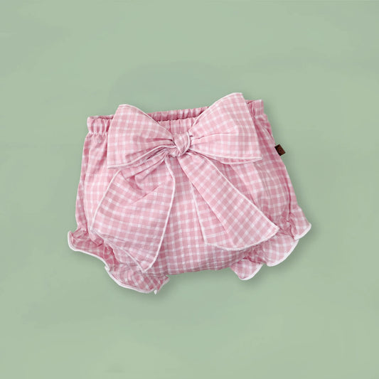 Tapa-fraldas de menina em tecido com laço na frente e folhos rosa