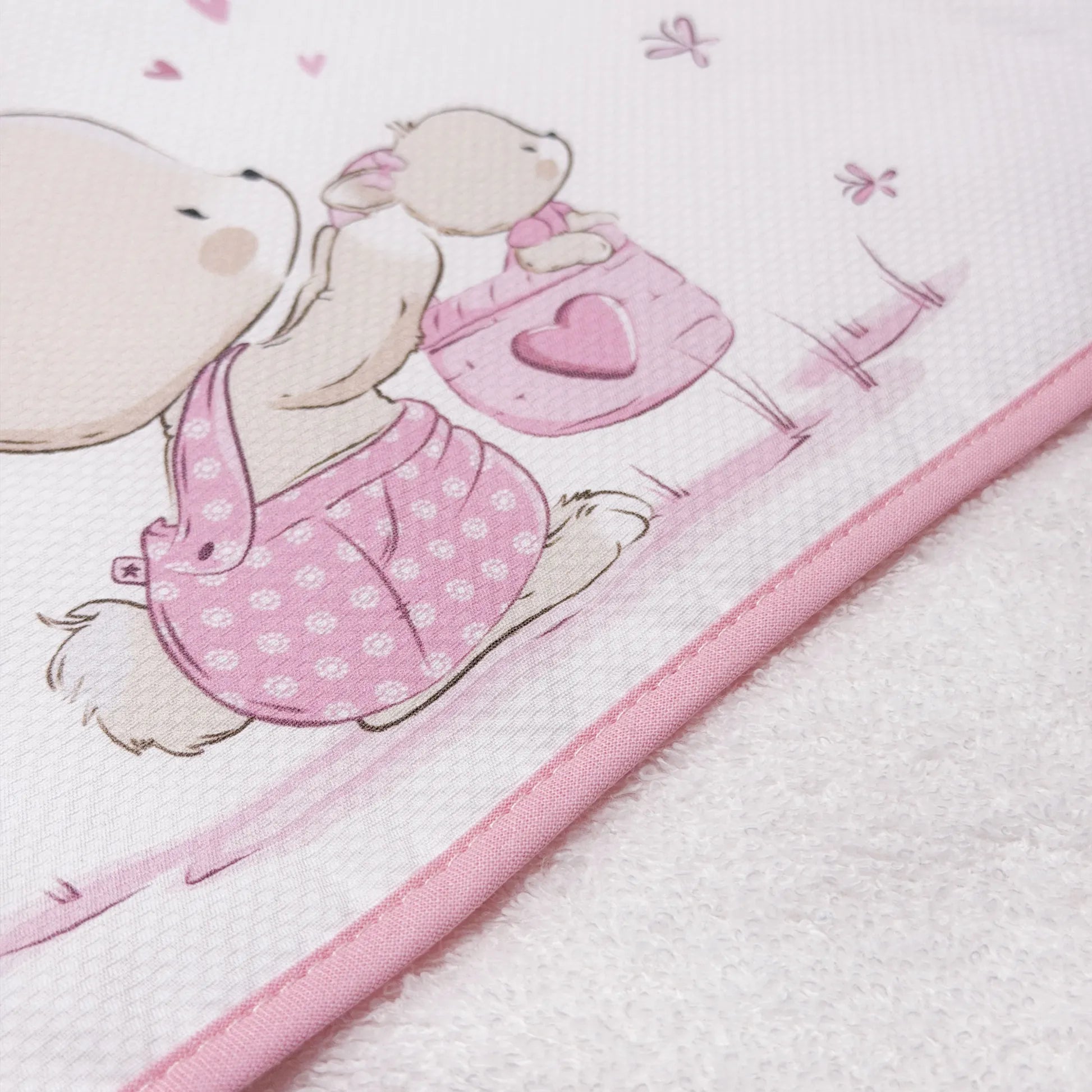 Pormenor de toalha com motivo coelhinho na cesta rosa